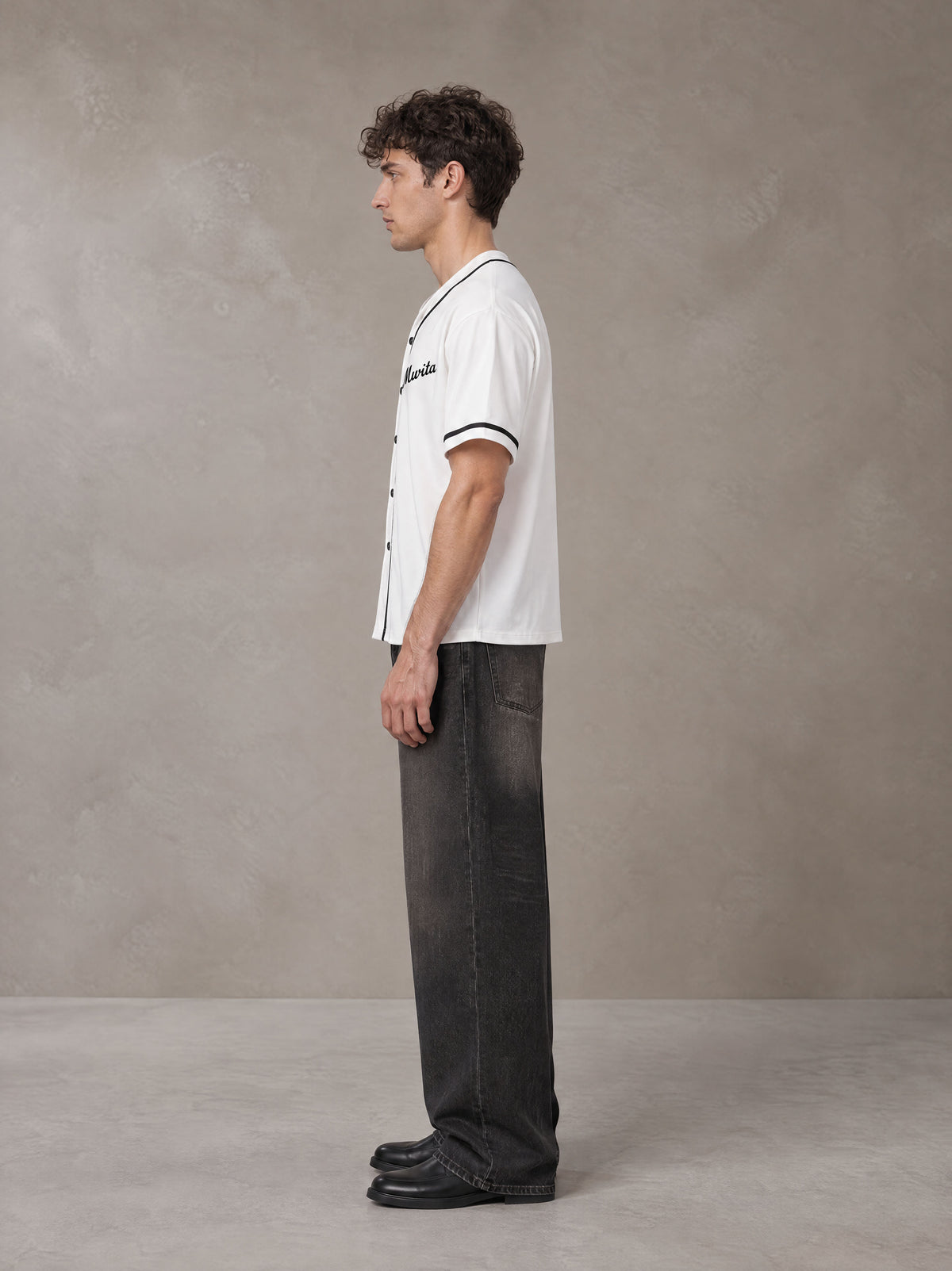 Model wearing the SM Dugout Atelier T-shirt in Lucent White, side profile.