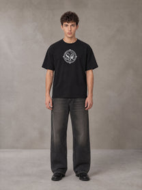 Model wearing the SM Emblem T-shirt in Midnight Black, front view.
