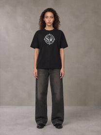Model wearing the SM Emblem T-shirt in Midnight Black, front view.