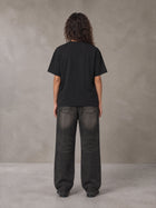 Model wearing the SM Emblem T-shirt in Midnight Black, rear view.