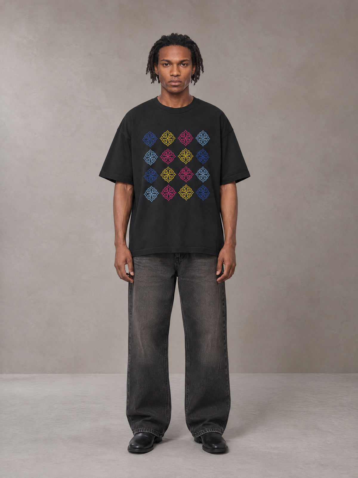 Model wearing the SM Fleur Matrix T-shirt in Midnight Black, front view.