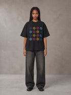 Model wearing the SM Fleur Matrix T-shirt in Midnight Black, front view.