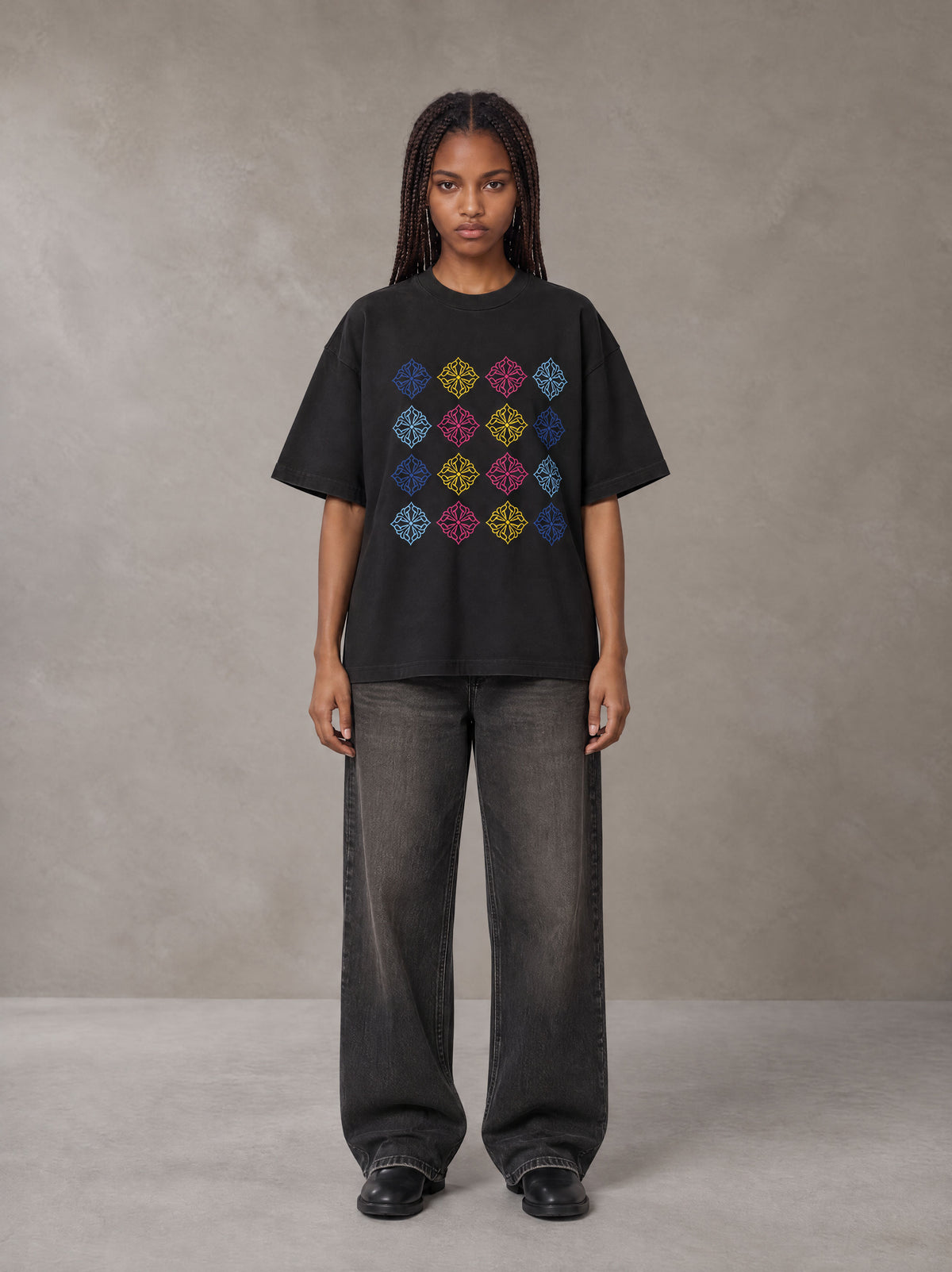 Model wearing the SM Fleur Matrix T-shirt in Midnight Black, front view.