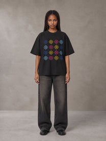 Model wearing the SM Fleur Matrix T-shirt in Midnight Black, front view.