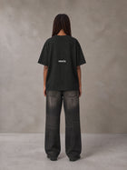 Model wearing the SM Fleur Matrix T-shirt in Midnight Black, rear view.
