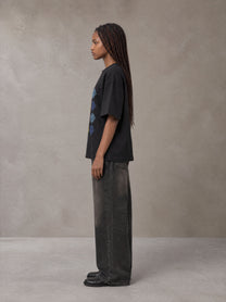 Model wearing the SM Fleur Matrix T-shirt in Midnight Black, side profile.