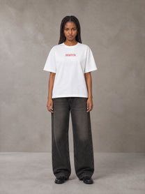 Model wearing the SM Floral Essence T-shirt in Lucent White, front view.