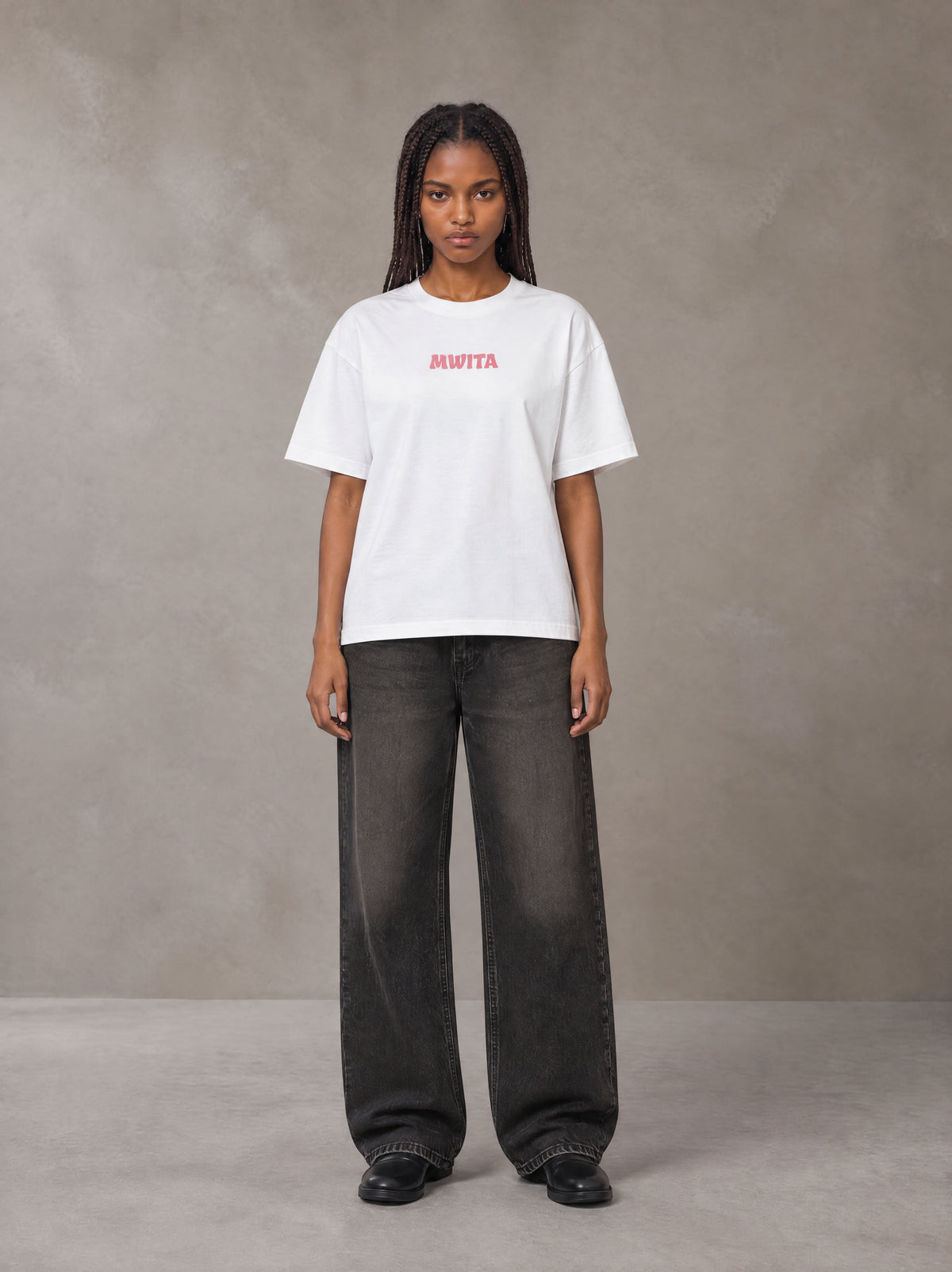 Model wearing the SM Floral Essence T-shirt in Lucent White, front view.