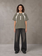 Model wearing the SM Graffiti Stack T-shirt in Coffee Grey, front view.