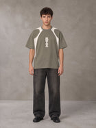 Model wearing the SM Graffiti Stack T-shirt in Coffee Grey, front view.