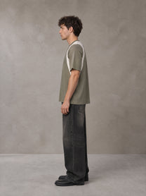 Model wearing the SM Graffiti Stack T-shirt in Coffee Grey, side profile.