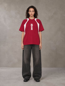 Model wearing the SM Graffiti Stack T-shirt in Crimson, front view.