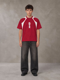 Model wearing the SM Graffiti Stack T-shirt in Crimson, front view.