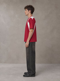 Model wearing the SM Graffiti Stack T-shirt in Crimson, side profile.