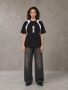 Model wearing the SM Graffiti Stack T-shirt in Midnight Black, front view.