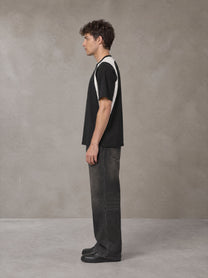 Model wearing the SM Graffiti Stack T-shirt in Midnight Black, side profile.