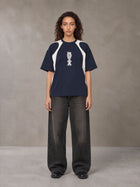 Model wearing the SM Graffiti Stack T-shirt in Oxford Navy, front view.