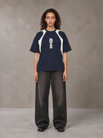 Model wearing the SM Graffiti Stack T-shirt in Oxford Navy, front view.