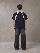 Model wearing the SM Graffiti Stack T-shirt in Oxford Navy, rear view.