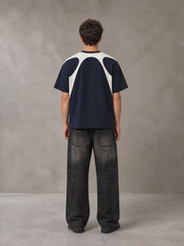 Model wearing the SM Graffiti Stack T-shirt in Oxford Navy, rear view.