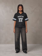 Model wearing the SM Gridiron T-shirt in Midnight Black, front view.