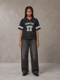 Model wearing the SM Gridiron T-shirt in Midnight Black, front view.