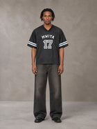 Model wearing the SM Gridiron T-shirt in Midnight Black, front view.