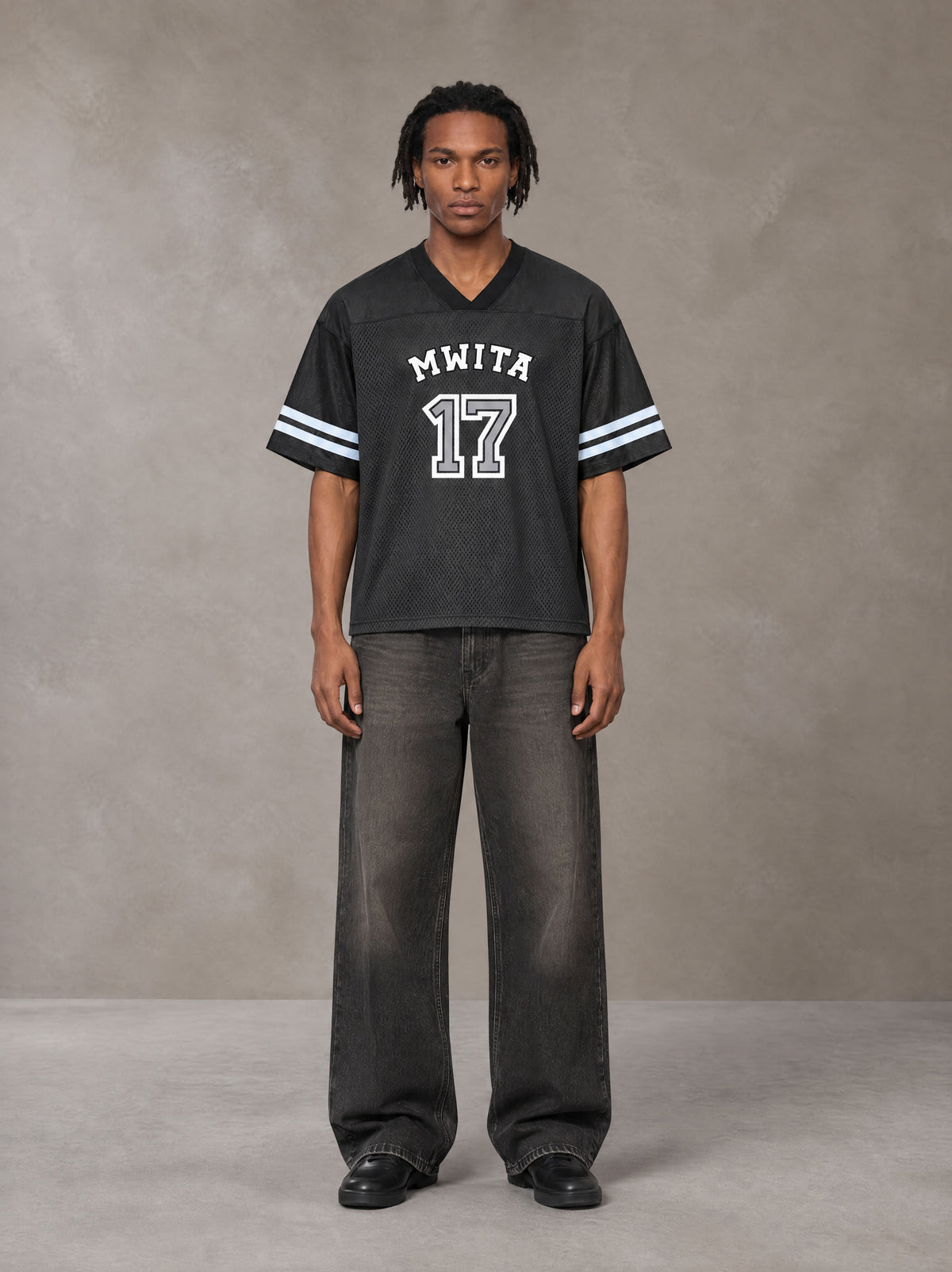 Model wearing the SM Gridiron T-shirt in Midnight Black, front view.