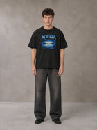 Model wearing the SM Halcyon T-shirt in Midnight Black, front view.
