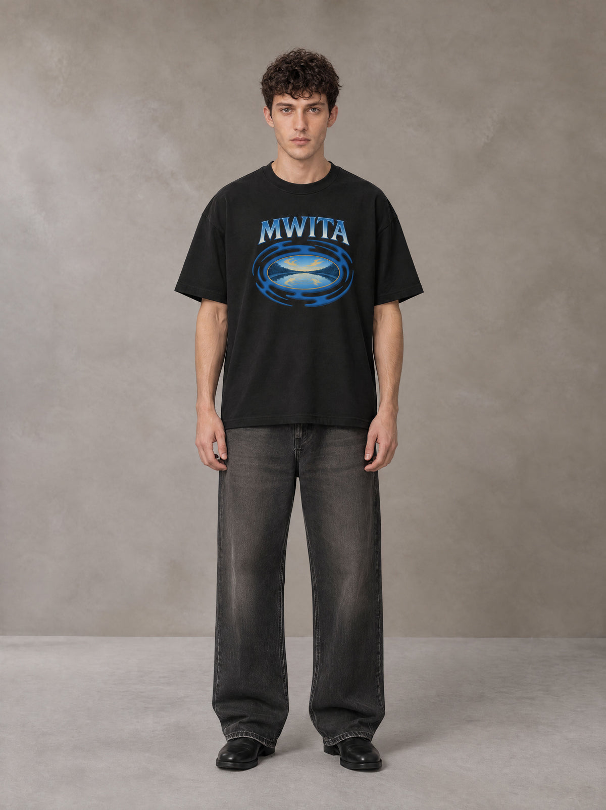 Model wearing the SM Halcyon T-shirt in Midnight Black, front view.