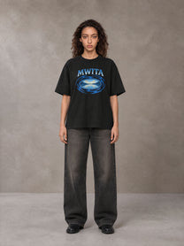 Model wearing the SM Halcyon T-shirt in Midnight Black, front view.