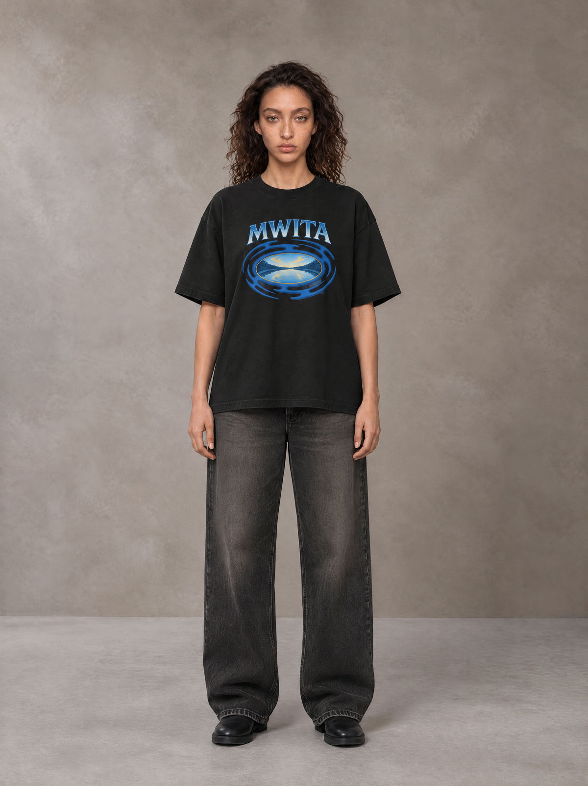 Model wearing the SM Halcyon T-shirt in Midnight Black, front view.