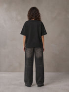 Model wearing the SM Halcyon T-shirt in Midnight Black, rear view.