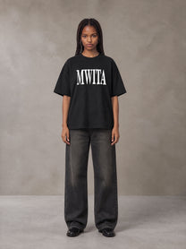 Model wearing the SM Heritage T-shirt in Midnight Black, front view.