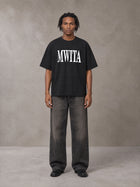 Model wearing the SM Heritage T-shirt in Midnight Black, front view.
