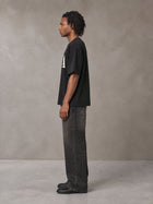 Model wearing the SM Heritage T-shirt in Midnight Black, side profile.