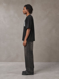 Model wearing the SM Heritage T-shirt in Midnight Black, side profile.