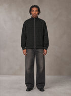 Model wearing the SM Jacquard Track Jacket in Midnight Black, front view.