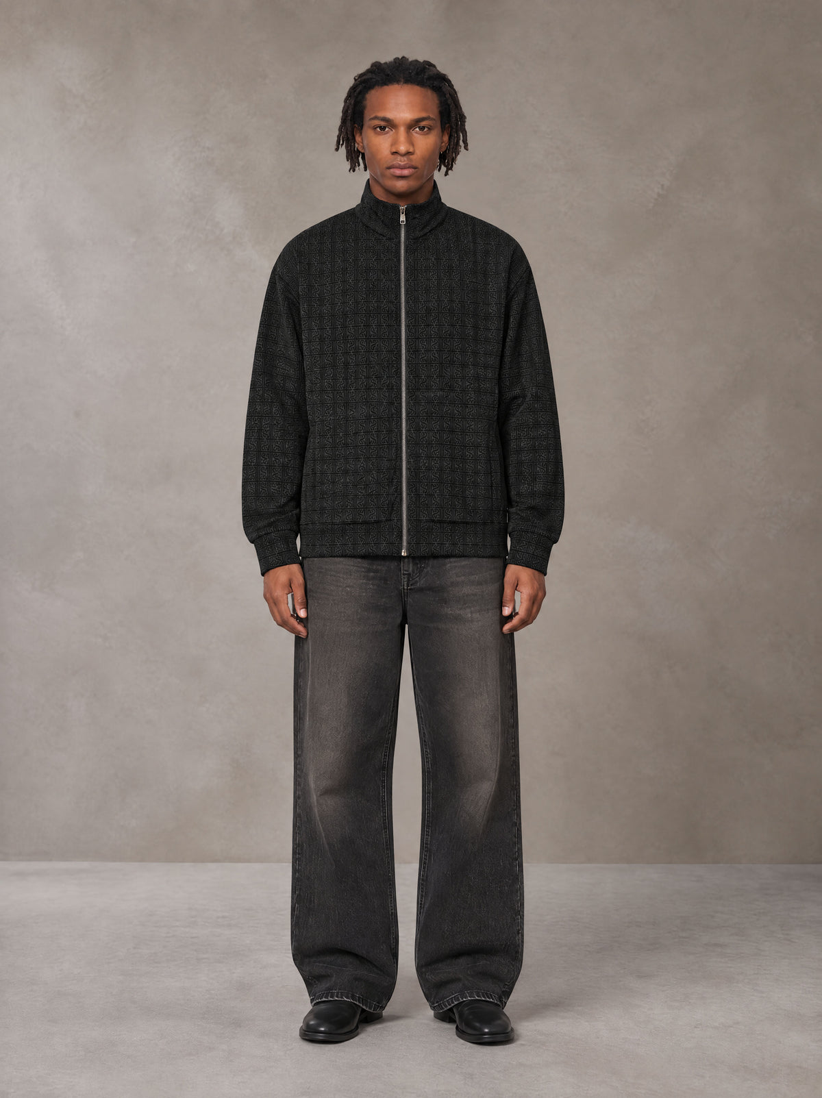 Model wearing the SM Jacquard Track Jacket in Midnight Black, front view.