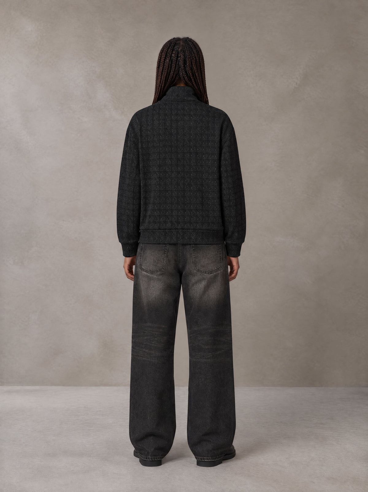 Model wearing the SM Jacquard Track Jacket in Midnight Black, rear view.