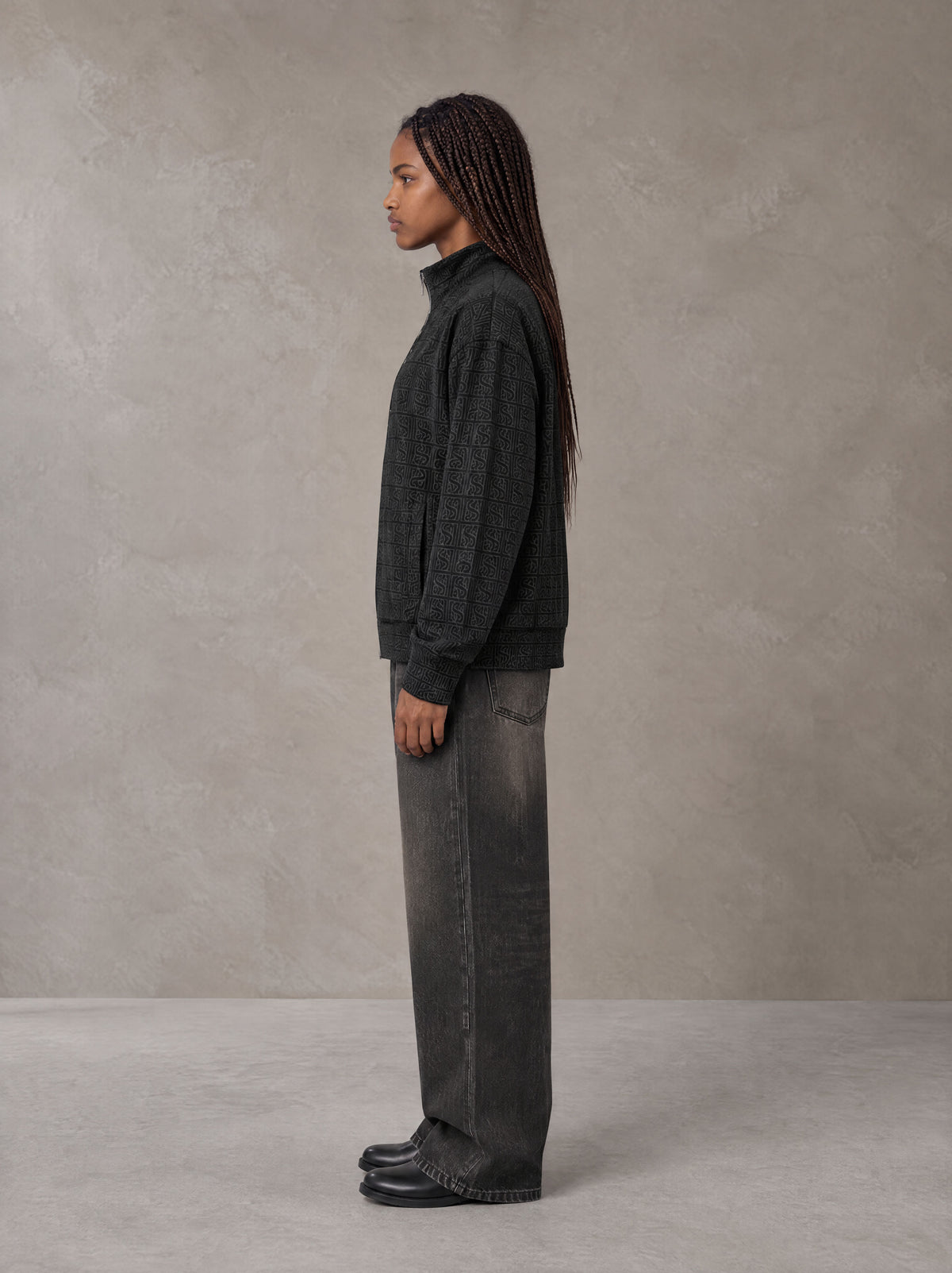 Model wearing the SM Jacquard Track Jacket in Midnight Black, side profile.