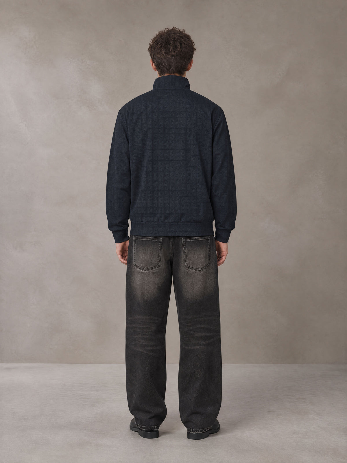 Model wearing the SM Jacquard Track Jacket in Oxford Navy, rear view.