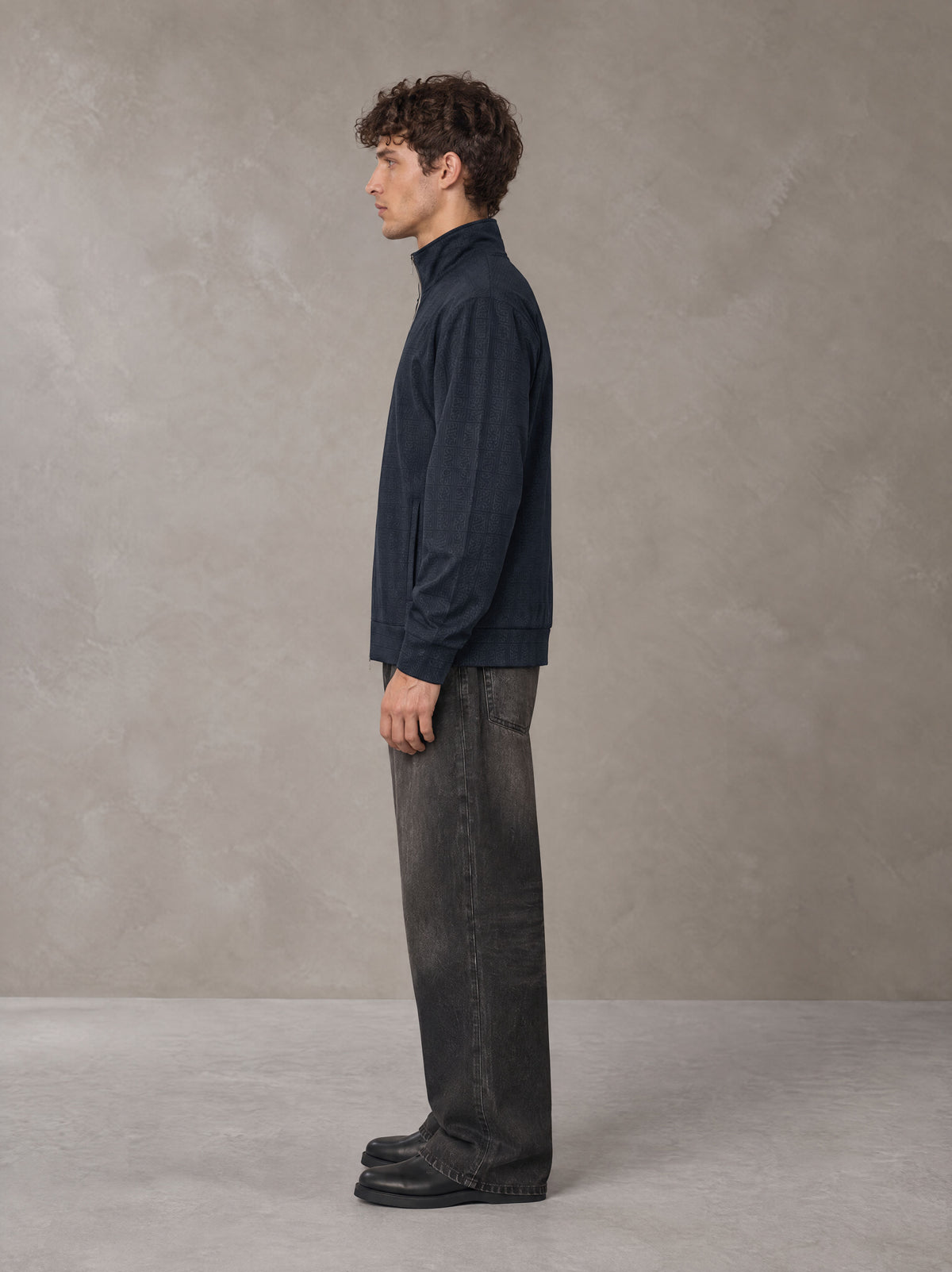 Model wearing the SM Jacquard Track Jacket in Oxford Navy, side profile.