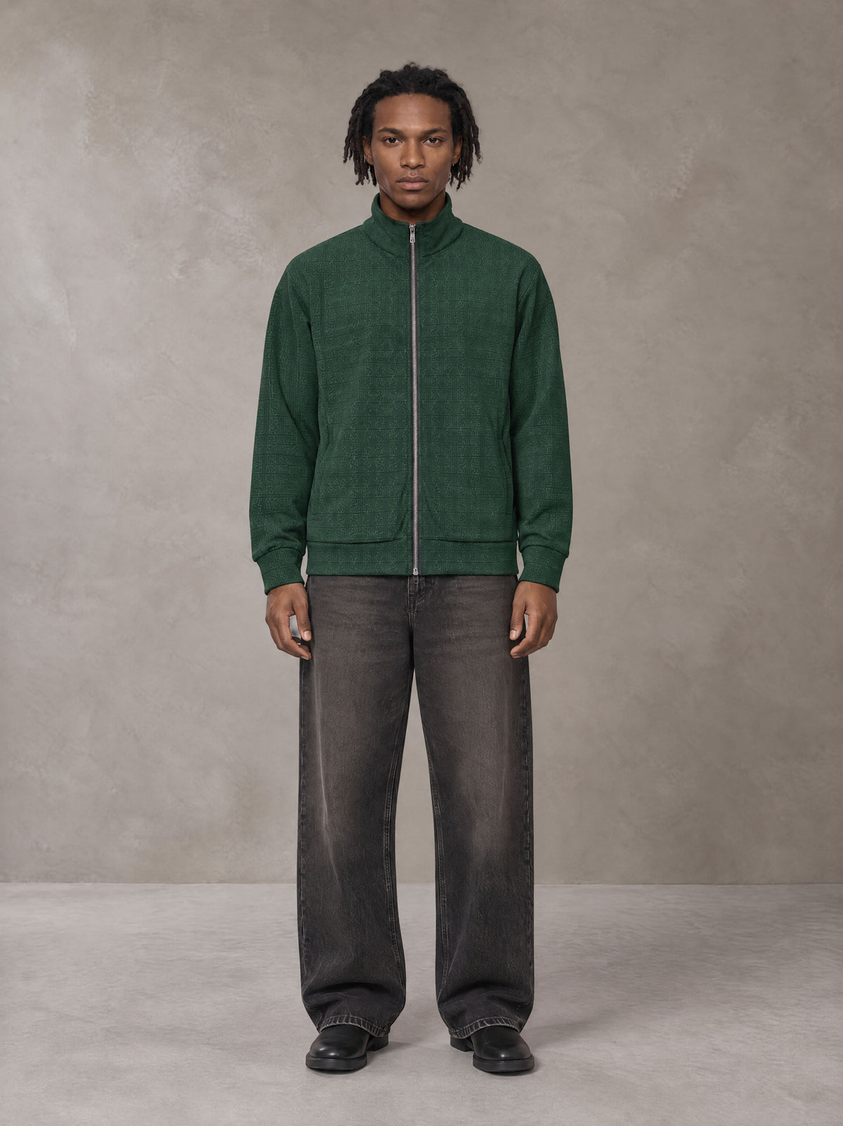 Model wearing the SM Jacquard Track Jacket in Alpine Green, front view.
