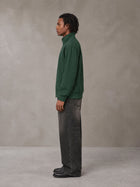 Model wearing the SM Jacquard Track Jacket in Alpine Green, side profile.