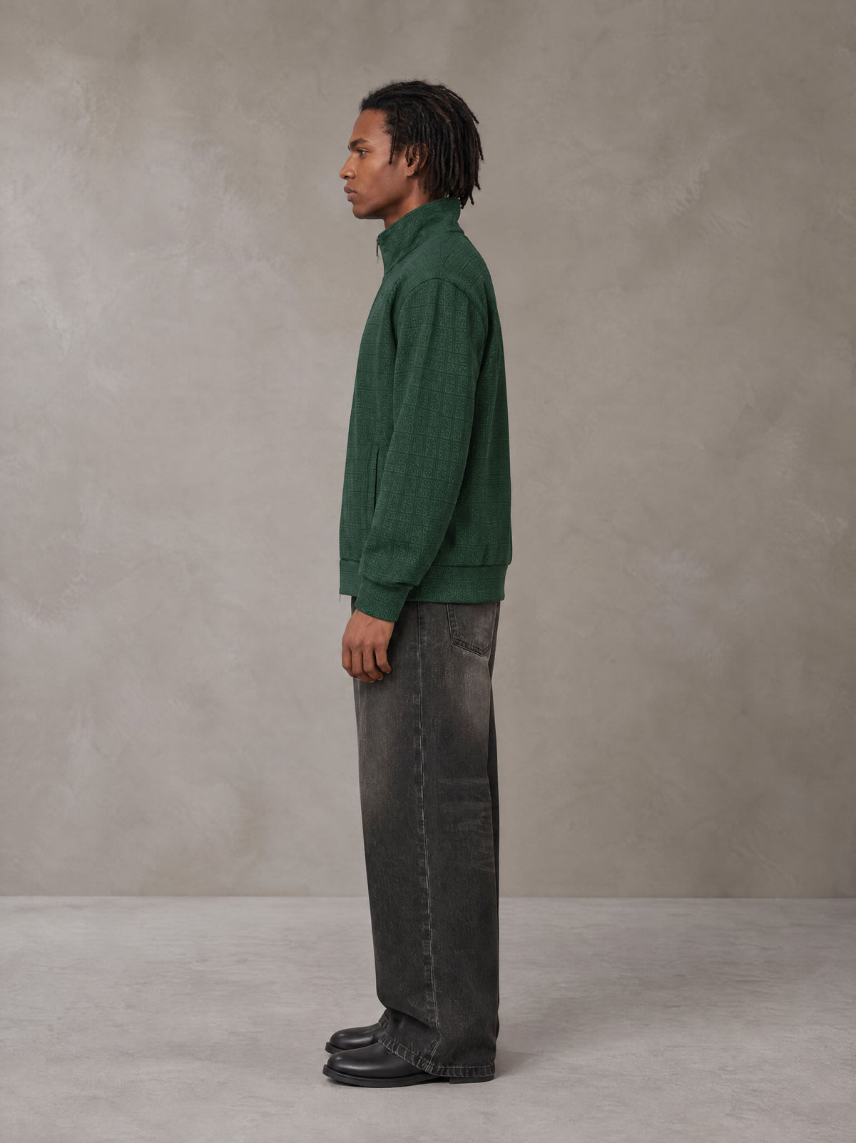 Model wearing the SM Jacquard Track Jacket in Alpine Green, side profile.
