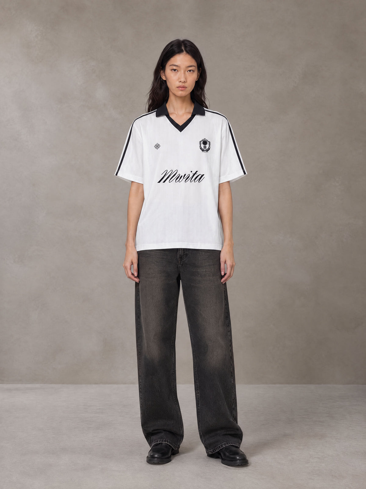 Model wearing the SM Legacy Jersey Polo T-shirt in Lucent White, front view.