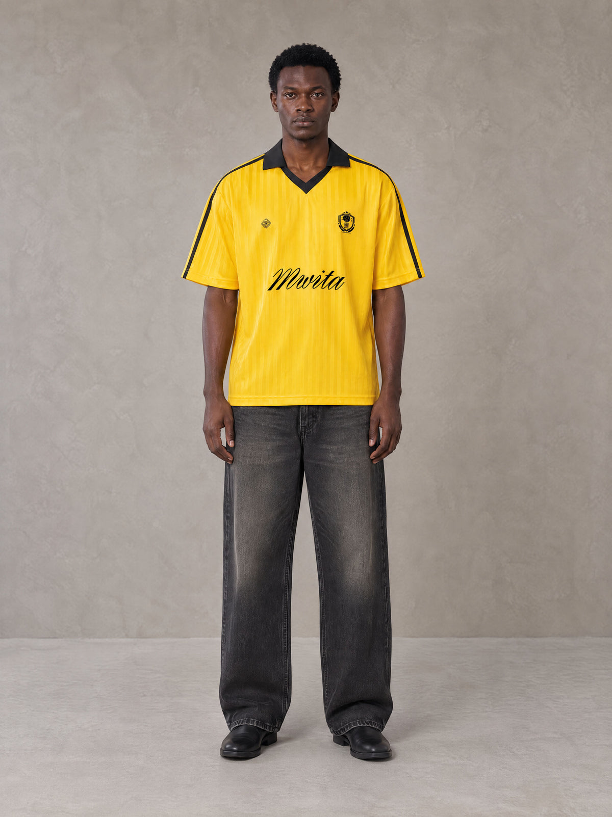 Model wearing the SM Legacy Jersey Polo T-shirt in Maize, front view.