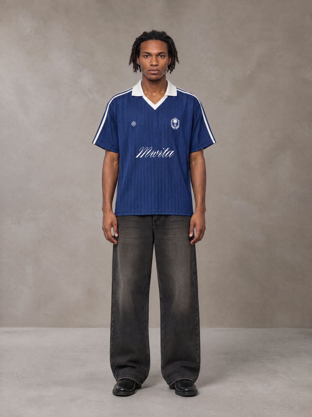 Model wearing the SM Legacy Jersey Polo T-shirt in Oxford Navy, front view.