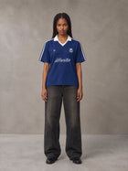 Model wearing the SM Legacy Jersey Polo T-shirt in Oxford Navy, front view.